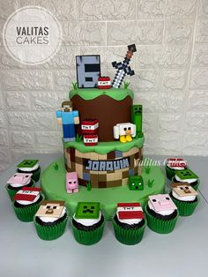 a cake made to look like a video game with cupcakes on the table