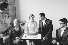 the bride and groom are getting ready for their wedding ceremony in black and white photo