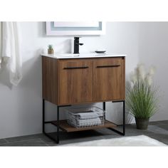 a bathroom vanity with two drawers and a white counter top next to a potted plant