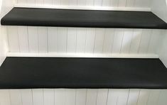 three black and white shelves on the wall