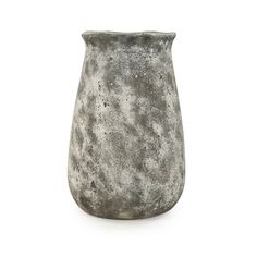 a gray vase sitting on top of a white table