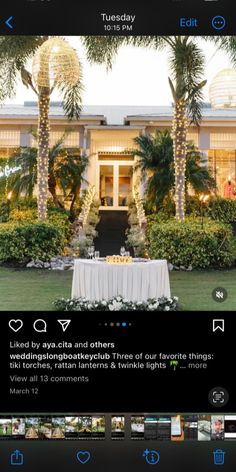 an image of a house with palm trees in the background and a table set up outside