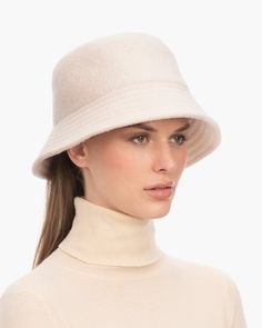 A cozy, lightweight women's bucket hat of spun wool with trapunto stitched brim rolls up easily into a coat pocket or a tote bag. Eric says, "It's definitely a bucket hat season where the attitude is a bit more casual than a fedora." What makes this women's bucket hat most desirable is that the crown is spun and then blocked to achieve the shape; The crown has no visible seams so it doesn't feel thick, while providing great insulation and protection from the elements. Brim span: 2.75"(7cm) Fully Bucket Light, Gold Sand, Coat Pocket, Navy Linen, Natural Gold, Hats For Sale, Fedora Hat, The Crown, Cream White