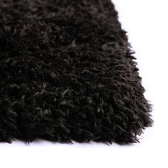 a black shaggy rug on a white background