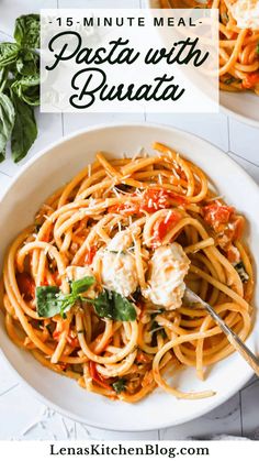 pasta with tomato sauce and parmesan cheese in a white bowl on top of a table