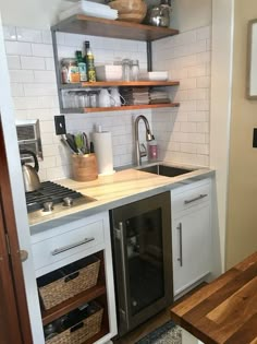 the kitchen is clean and ready to be used as a storage area for wine bottles