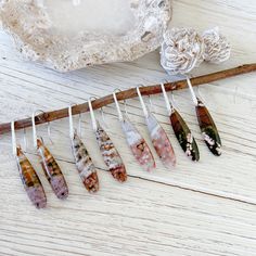 I hand picked these stones from the Tucson Gem & Mineral Show.  Ocean Jasper does not disappoint with its unique color variations on each stone pair.   These are oblong tear drop in shape and dangle from a beautiful textured Sterling Silver Plated bail/ear wires. Approx 2 1/8" Long Pick your Fave! A. Cream, Caramel, Ivy Green and Lavender colorations B. Cream, Rust, Caramel, Dark Green colorations C. Creams & soft pinks with druzy hole thru to the other side D. Milk chocolate brown, dark green and soft pinks *Ocean Jasper  (also known as ocean orbicular jasper) is said to be a highly spiritual and protective stone that helps to connect the wearer with the spiritual realm. It also aids in the removal of negative energy and stress, while promoting feelings of peace and calm. In addition, Oce Orbicular Jasper, Green And Lavender, Cream Caramel, Spiritual Realm, Pink Ocean, Earring Gift, Natural Stone Jewelry, Earrings Minimalist, Ocean Jasper