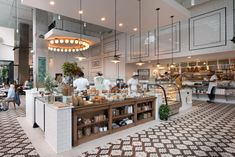 the inside of a restaurant with people sitting at tables