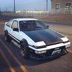 a white and black car parked in the street