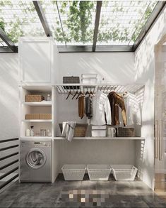 a washer and dryer in a room next to a window with an awning