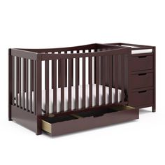 a baby crib with drawers in front of it and an open drawer underneath the crib