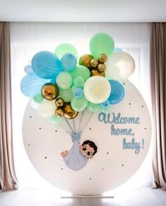 a balloon filled with balloons in the shape of a baby's head and words welcome home, baby