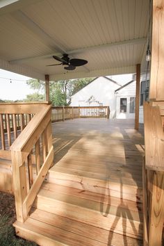 a porch with wooden steps and a ceiling fan