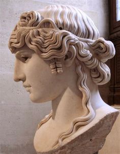 a statue of a woman's head with wavy hair