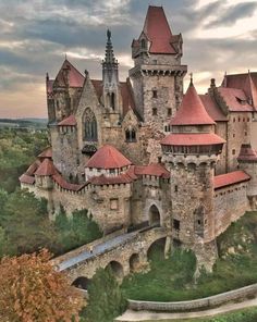 an old castle with red roof and towers