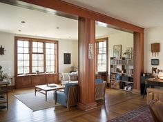 a living room filled with furniture and lots of windows