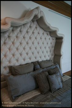 the headboard and pillows are upholstered on this bed