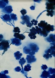 a blue and white painting with flowers on it