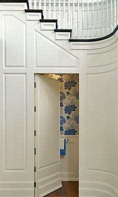 an open door leading to a white staircase