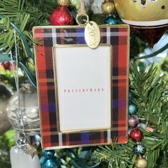 an ornament hanging from a christmas tree with ornaments around it and the word happy birthday