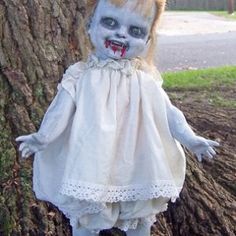 a creepy doll standing next to a tree