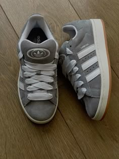 The Adidas Campus 00s sneakers have a low-top, old-school style structure. The upper features a grey suede overlay, topped with white reinforcements on the quarter. You'll find the inimitable trefoil logo on the heel and tongue. Viral Shoes 2023, Shoe Wishlist, Aesthetic Shoes