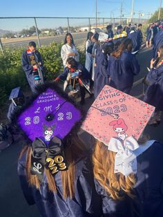 a group of people in graduation caps and gowns walk down the street with other people