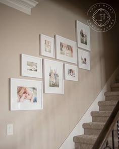 a staircase with pictures on the wall above it