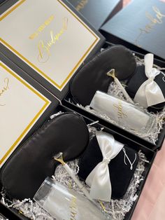 three black and white wedding favors in a box