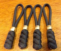 three black ropes with gold ends on a wooden table