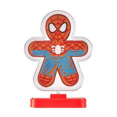 a spiderman shaped paper toy on top of a red stand