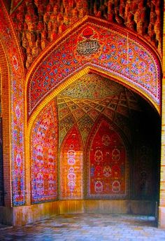 an artistic photo of the inside of a building with intricate designs and colors on it