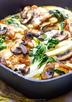 a pan filled with pasta and mushrooms on top of a table