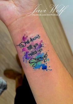 a wrist tattoo with some writing on it