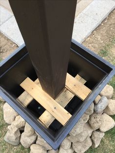 a metal pole sitting on top of a pile of rocks