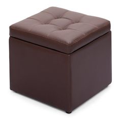 a brown leather ottoman sitting on top of a white floor