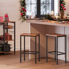 two stools in front of a counter with christmas decorations