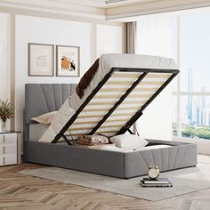 a bed with a mattress on top of it in a room next to a window