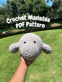 a hand holding a crochet stuffed animal with the words crochet manatee pop pattern on it