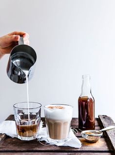 a person pours coffee into two glasses