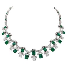 Twenty shimmering scalloped ribbons of baguette diamonds—twelve shallows and eight deeply curved—undulate around the neck interspersed with circular-cut emeralds and circular-cut diamonds and in this exquisitely designed Contemporary Diamond Emerald Fringe Festoon Bib Necklace, made in the 21st century. The sparkling piece harkens back to the luxury of Belle Époque jewelry, which portrayed Neoclassical and Rococo motifs of 18th-century French courts. Garlands and swags of foliate motifs, lace, a Rococo Motifs, Festoon Necklace, Jewelry Design Drawing, Big Diamond, Baguette Diamonds, Pear Shaped Diamond, Green Gemstones, Neoclassical, Bib Necklace