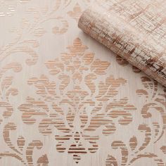 a close up view of a wallpaper with an intricate design on the fabric and wood grains