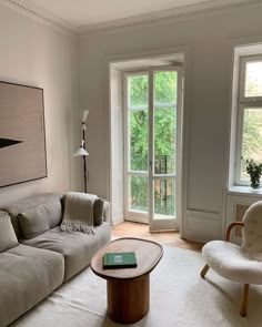 a living room filled with furniture and a large window