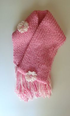 "-Made with soft 100% acrylic yarn, this handknitted scarf is sure to keep any neck warm during cold weather. -With dimensions of 70\" x 7\", women will be encouraged to wear their scarf in any style they choose. -This scarf is adorned with three flowers in soft pink; one in the center, and two near the ends of the scarf. These flowers are also made from 100% acrylic yarn. -Tassels, the same colors as the scarf, measure about 8 inches long. -Washing instructions: hand wash in cold water, lay flat to dry." Scarf With Tassels, Three Flowers, Pink Scarf, Flower Scarf, Be Encouraged, Pink Scarves, Women Pink, Knitting Accessories, Dream Clothes