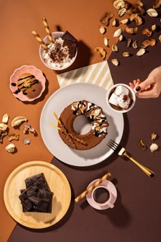 a table topped with plates and bowls filled with desserts