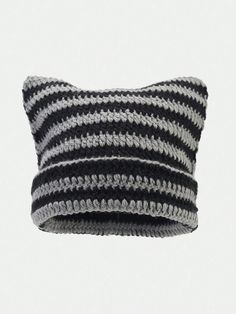 a black and white striped pillow sitting on top of a table