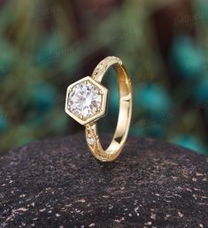 a diamond ring sitting on top of a rock