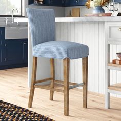 a blue and white striped bar stool in a kitchen