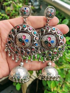 Add charm and charisma to your beautiful personality with these exquisitely handcrafted Afghani earrings jhumkas made with high quality German Silver. The intricate design and the glass enamel work renders these earrings a very unique and classy look. Pair them up with any formal or casual attire and gather compliments all the way!Weight  36 gmLength 4 inches Width 1.8" inches Bohemian Heavy Drop Chandelier Earrings, Handmade Metal Dangle Jhumkas, Handmade Metal Jhumkas, Temple Jewelry Festival Earrings With Latkans, Bohemian Drop Jhumkas In Metal, Multicolor Chandbali Jhumkas With Intricate Design, Bohemian Dangle Jhumkas, Bohemian Jhumkas With Intricate Design, Multicolor Bollywood Round Earrings