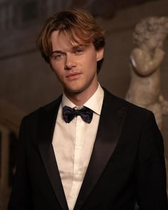 a young man in a tuxedo and bow tie